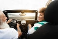 Happy senior couple having fun in convertible car during summer vacation - Focus on woman face Royalty Free Stock Photo