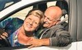 Happy senior couple having fun driving car trip on the road Royalty Free Stock Photo