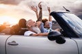 Happy senior couple having fun driving on new convertible car - Mature people enjoying time together during road trip Royalty Free Stock Photo