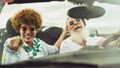 Happy senior couple having fun driving on new convertible car - Mature people enjoying time together during road trip Royalty Free Stock Photo