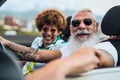 Happy senior couple having fun driving on new convertible car - Mature people enjoying time together during road trip Royalty Free Stock Photo