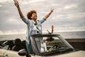 Happy senior couple having fun driving on new convertible car - Mature people enjoying time together during road trip tour Royalty Free Stock Photo