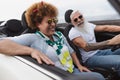 Happy senior couple having fun driving on new convertible car - Mature people enjoying time together during road trip Royalty Free Stock Photo