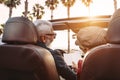 Happy senior couple having fun on new convertible car - Mature people enjoying time together during road trip vacation Royalty Free Stock Photo