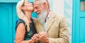 Happy senior couple having tender moments outdoor - Mature people enjoying time together - Love, fashion and joyful elderly active Royalty Free Stock Photo