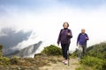 Happy senior couple hiking on the mountain
