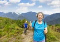 Happy Senior  couple hiking on the  mountain and showing thumb up Royalty Free Stock Photo