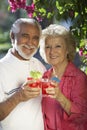Happy Senior Couple Holding Drinks Outdoors Royalty Free Stock Photo