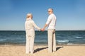 Happy senior couple holding hands summer beach Royalty Free Stock Photo