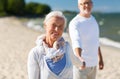 Happy senior couple holding hands on summer beach Royalty Free Stock Photo