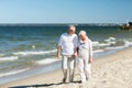 Happy senior couple holding hands on summer beach Royalty Free Stock Photo