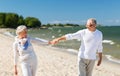 Happy senior couple holding hands on summer beach Royalty Free Stock Photo