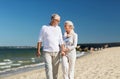 Happy senior couple holding hands on summer beach Royalty Free Stock Photo