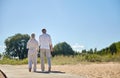Happy senior couple holding hands on summer beach Royalty Free Stock Photo