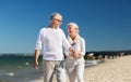 Happy senior couple holding hands on summer beach Royalty Free Stock Photo