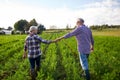 Happy senior couple holding hands at summer farm Royalty Free Stock Photo