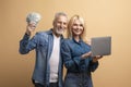 Happy senior couple holding money cash and laptop Royalty Free Stock Photo