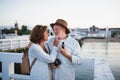 Happy senior couple hugging outdoors on pier by sea, looking at each other. Royalty Free Stock Photo