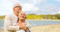 Happy senior couple hugging over beach background Royalty Free Stock Photo