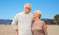 Happy senior couple hugging over venice beach Royalty Free Stock Photo