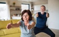 A senior couple indoors at home, doing exercise indoors. Royalty Free Stock Photo