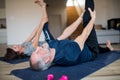 A senior couple indoors at home, doing exercise in living room. Royalty Free Stock Photo