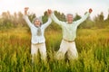 Happy senior couple jumping in summer park Royalty Free Stock Photo