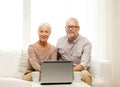 Happy senior couple with laptop and cups at home Royalty Free Stock Photo