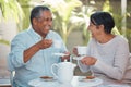 Happy senior couple, laughing and drinking coffee in cheerful fun together at outdoor cafe or restaurant. Elderly man Royalty Free Stock Photo