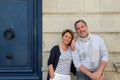 Happy senior couple leaning on city building wall Royalty Free Stock Photo