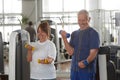 Happy senior couple lifting dumbbells at gym. Royalty Free Stock Photo