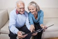 Happy senior couple looking at spiral book