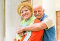 Happy senior couple in love enjoying romantic vacation in Italy - Husband hugging his wife holding a smartphone - Joyful elderly Royalty Free Stock Photo