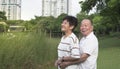 Happy senior couple in love, man hug wife. Park outdoors setting Royalty Free Stock Photo