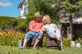 Happy senior couple in love relaxing together in the garden in a Royalty Free Stock Photo