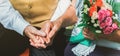 Happy senior couple love story. Old couple is sitting on bench in the green park. Grandmother and grandfather holding hands. Royalty Free Stock Photo