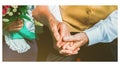 Happy senior couple love story. Old couple is sitting on bench in the green park. Grandmother and grandfather holding hands. Royalty Free Stock Photo