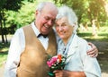 Happy senior couple love story. Old couple is walking in the green park. Grandmother and grandfather laughing. Elderly people Royalty Free Stock Photo
