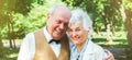 Happy senior couple love story. Old couple is walking in the green park. Grandmother and grandfather laughing. Elderly people Royalty Free Stock Photo