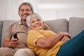 Happy senior couple, love and watching tv relax together on living room sofa at family home. Elderly married man and Royalty Free Stock Photo
