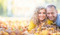 Happy senior couple lying in autumn maple leaves Royalty Free Stock Photo