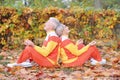 Happy senior couple meditating in autumn park Royalty Free Stock Photo