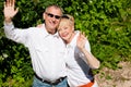 Happy senior couple outdoors waving hands Royalty Free Stock Photo