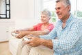 Happy senior couple playing video games Royalty Free Stock Photo