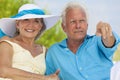 Happy Senior Couple Pointing on A Tropical Beach Royalty Free Stock Photo