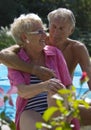 Happy senior couple on pool