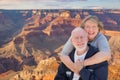 Happy Senior Couple Posing on Edge of The Grand Canyon Royalty Free Stock Photo