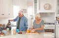 Happy senior couple preaparing a healthy breakfast in their kitchen Royalty Free Stock Photo