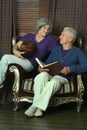 Happy senior couple reading book at home Royalty Free Stock Photo