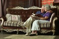 Happy senior couple reading book at home Royalty Free Stock Photo